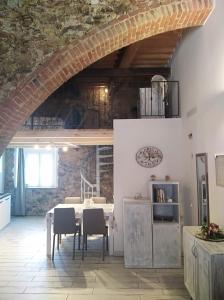 a dining room with a table in a room at Casa Leo in Capoliveri +11 photos