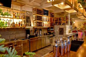 a kitchen with a counter and a bar with bottles at Georgia's Garden by Omilos Hotels in Amoudara Herakliou