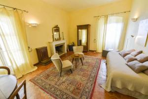 a living room with a bed and a couch and a table at Hotel Palazzu Pigna in Pigna