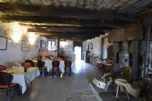 a dining room with tables and chairs in a building at Hotel Palazzu Pigna in Pigna