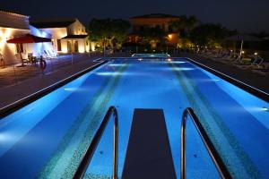 a large swimming pool at night with lights at Case Vacanza SANT'AGOSTINO Siracusa in Siracusa