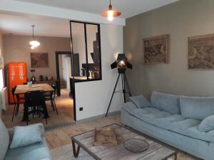 a living room with a couch and a table at La Famiglia in Étretat