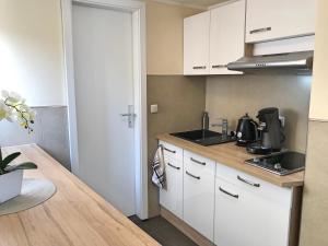 a kitchen with white cabinets and a counter top at Fewo Zur Goldenen Traube in Rüdesheim am Rhein