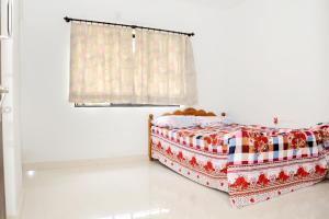 a bedroom with a bed and a window at Single Sharing Bedroom in Two ROOM APARTMENT in Udupi