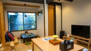 a living room with a television and a table at Hotel Yori Toya / Vacation STAY 24393 in Kyoto