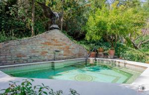 a swimming pool in a backyard with a brick wall at La Torretta di Francavilla al Mare in Francavilla al Mare