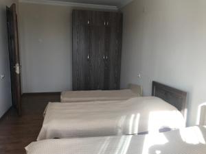 a bedroom with two beds and a closet at Apartment Mandarina in Kobuleti