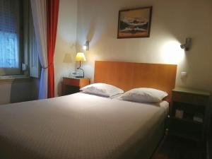 a bedroom with a large white bed and a window at Brasilia in Lisbon
