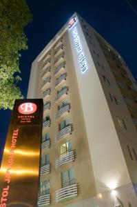 a tall building with a clock on the top of it at Bristol Jaraguá Hotel Pampulha in Belo Horizonte