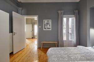 - une chambre avec un lit et du parquet dans l'établissement Bright Bright B Central Apartment with Balcony, à Thessalonique