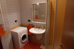 a bathroom with a sink and a washing machine at Appartamento Madonnina in Trieste +13 photos