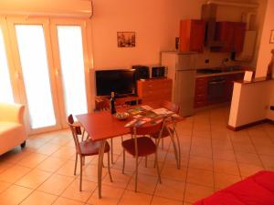 a kitchen with a table and chairs in a room at Appartamento Madonnina in Trieste