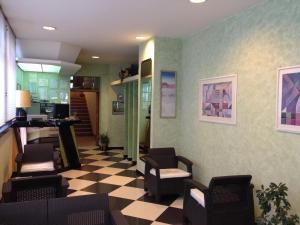 a waiting room with chairs and a checkered floor at Hotel Ristorante Stellato in Trebisacce
