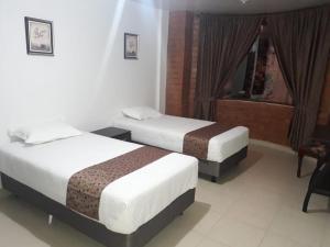 Postel nebo postele na pokoji v ubytování Hotel Kampak Wasi