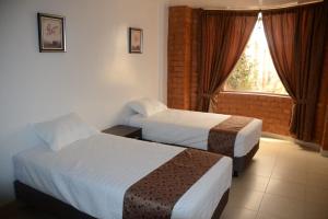 Postel nebo postele na pokoji v ubytování Hotel Kampak Wasi