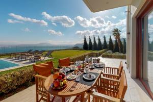 a wooden table with fruit on it on a patio at Ocean Villas Complex in Agia Pelagia