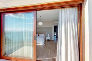 a sliding glass door leading to a bedroom at Ocean Villas Complex in Agia Pelagia +94 photos