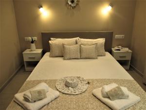 a bedroom with a large bed with two towels on it at Jolen House in Skala Kallirachis