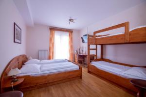 a bedroom with two bunk beds and a desk at Tourist farm Pri Andrejevih in Narin