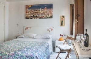 a bedroom with a bed and a desk with a chair at Monolocale Gallo in Florence