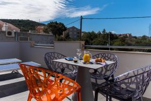 a table and chairs on a balcony with a view at Villa Maja in Cavtat