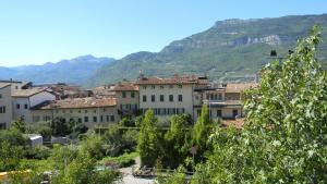 a group of buildings in front of a mountain at B&B Ai Colli in Rovereto