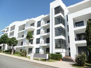 an image of a white apartment building at Vista das Ondas Olhos de Agua Apartment in Olhos de Água