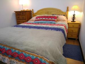 a bedroom with a bed and a dresser with a lamp at Casa Rústica in Finestrat +52 photos