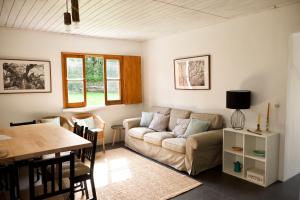 a living room with a couch and a table at #Areias Houses 9 in Furnas