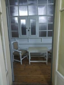 a room with a table and a chair and a window at De La Poste in Port Said