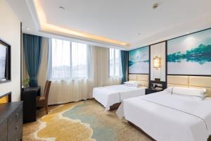 Postel nebo postele na pokoji v ubytování Yiwu Luckbear Hotel + 37 fotografií