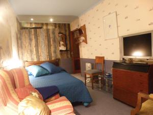 a bedroom with a bed and a flat screen tv at La NANA del MAR / The LULLABY of the SEA on old harbour in Cudillero