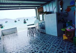 a kitchen with a table and a view of the beach at Nam Du VIEW Guest House in Nam Du