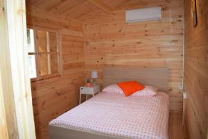 a bedroom with a bed in a wooden cabin at Cyprus Glamping Park in Ayios Theodhoros