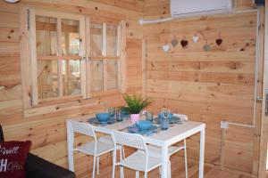a dining room with a white table and chairs at Cyprus Glamping Park in Ayios Theodhoros