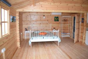 a room with a bed in a log cabin at Cyprus Glamping Park in Ayios Theodhoros