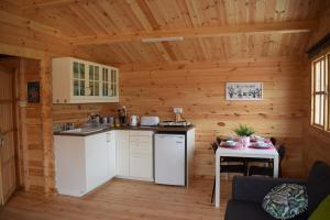 a kitchen in a log cabin with a table at Cyprus Glamping Park in Ayios Theodhoros