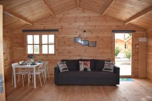 a living room with a couch and a table at Cyprus Glamping Park in Ayios Theodhoros