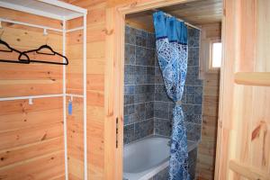a bathroom with a tub in a wooden cabin at Cyprus Glamping Park in Ayios Theodhoros
