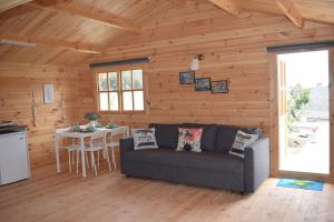 a living room with a couch and a table at Cyprus Glamping Park in Ayios Theodhoros