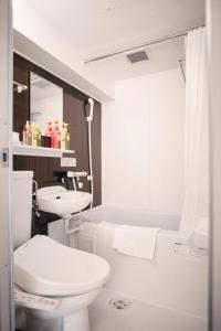 a bathroom with a toilet and a sink and a tub at Hotel She, Kyoto in Kyoto