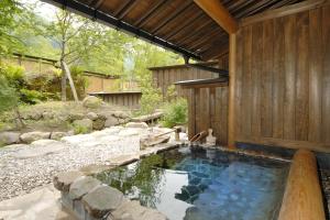 a swimming pool in the backyard of a house at Katsuragi no Sato in Takayama