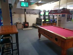 a room with a pool table and a bar at Gretna Hotel Taihape in Taihape
