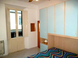 a bedroom with a bed and a cabinet and a window at Grottammare mon amour Levante in Grottammare