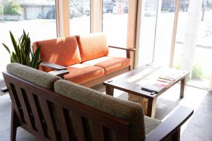 a living room with a couch and a coffee table at BEACH AND FIELD INN in Sapporo