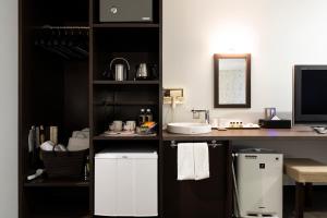 a kitchen with a desk with a sink and a refrigerator at Hotel Berlinetta Karuizawa in Karuizawa +54 photos