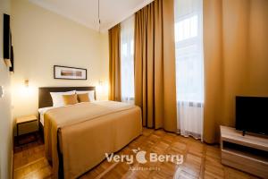 a hotel room with a bed and a television at Very Berry - Podgorna 1c - Old City Apartments, check in 24h in Poznań