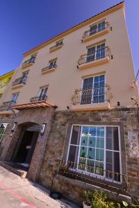 a building with windows and balconies on a street at Kenting Garden Homestay in Kenting