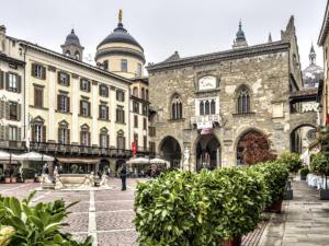 a city square with buildings and a cathedral at MyRoom Station In Town 2 in Bergamo