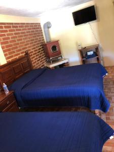 Postel nebo postele na pokoji v ubytování Cabañas las Gemelas